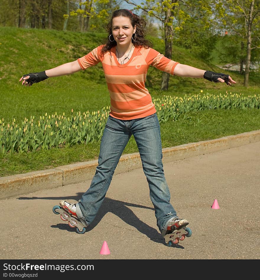 Smiling Rollerskating Girl Outdoors on Green Background