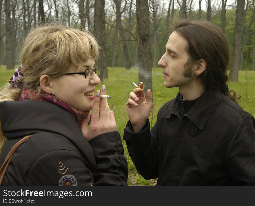 Girl and man are smoking