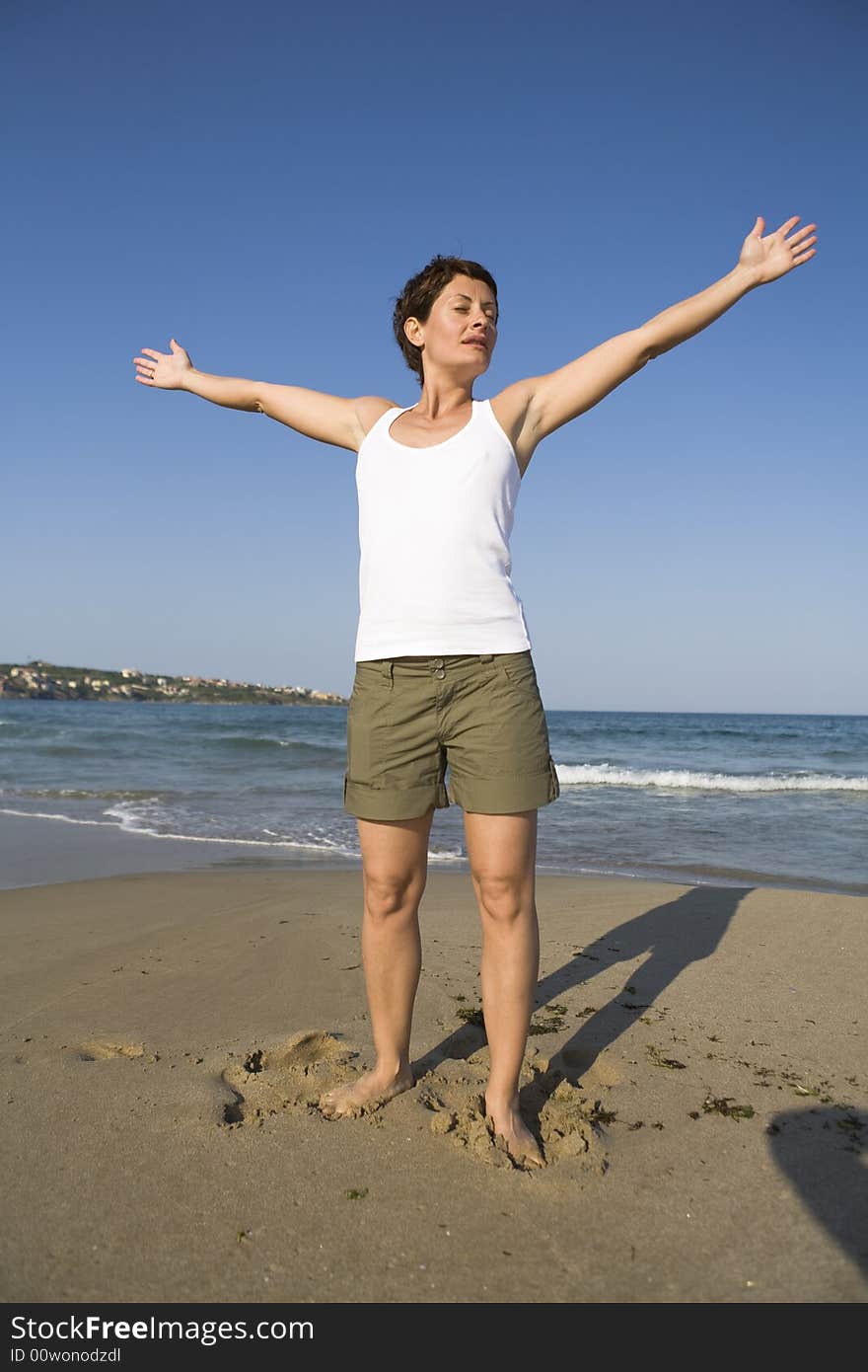 Young girl exercises gymnastics on the beach