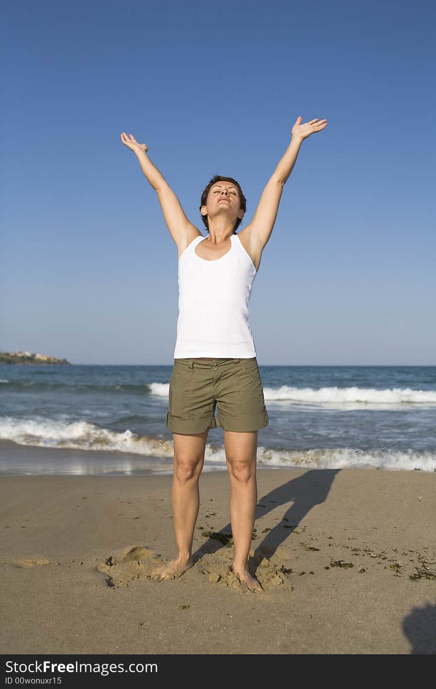 Young girl exercises gymnastics on the beach