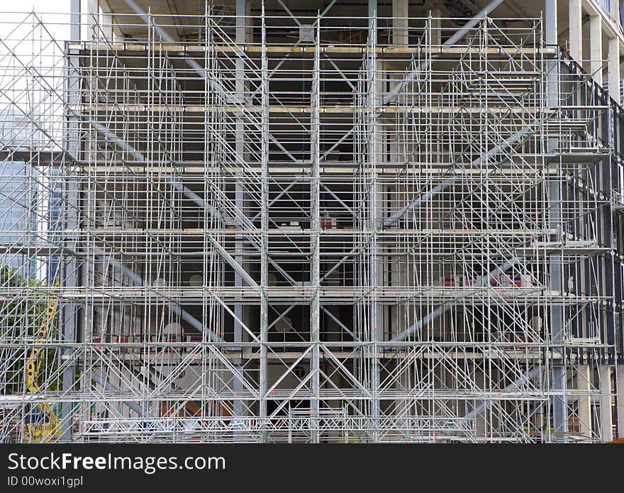 Complex scaffolding for skyscraper under construction. Complex scaffolding for skyscraper under construction