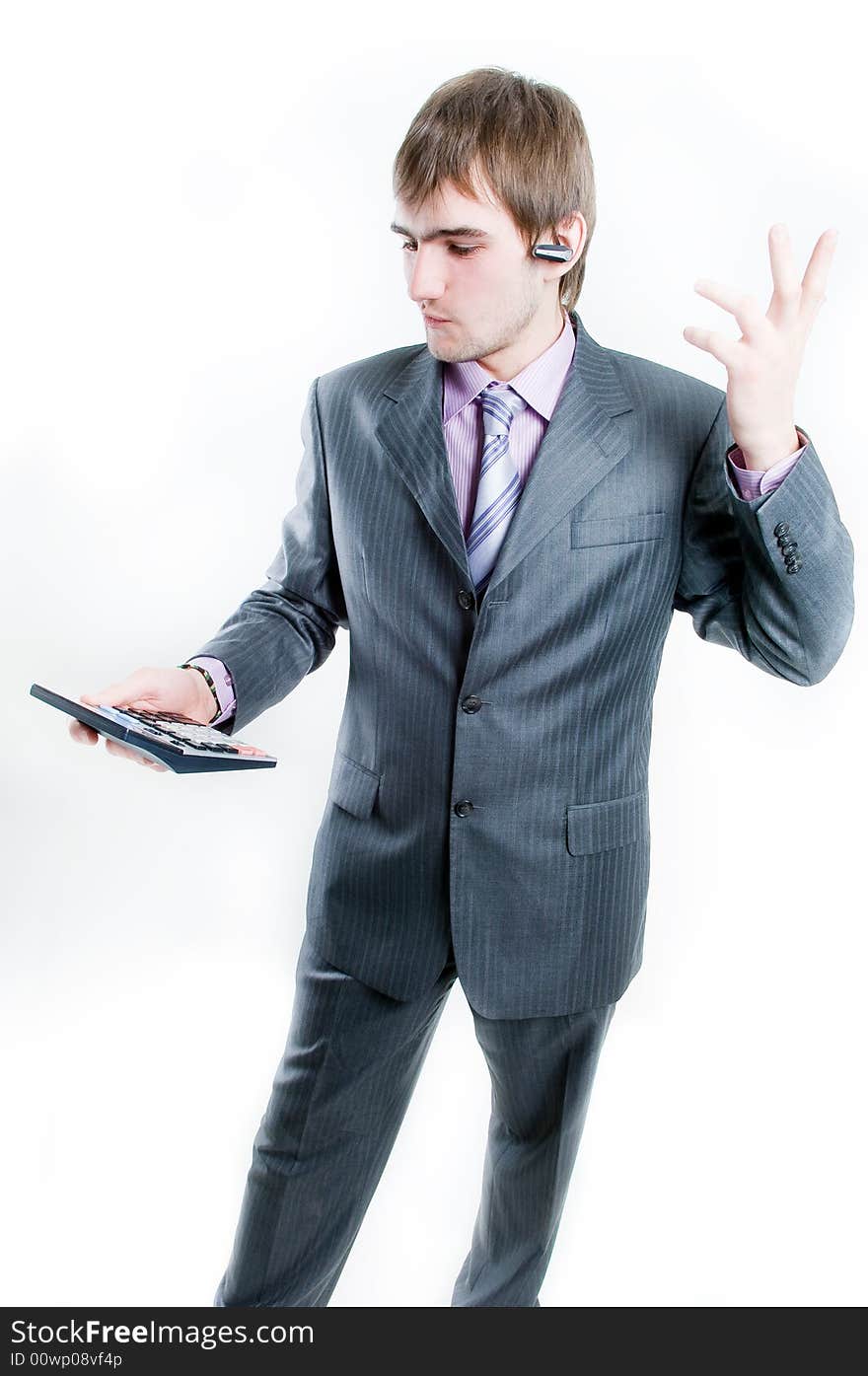 Upset businessman with calculator, isolated on white background