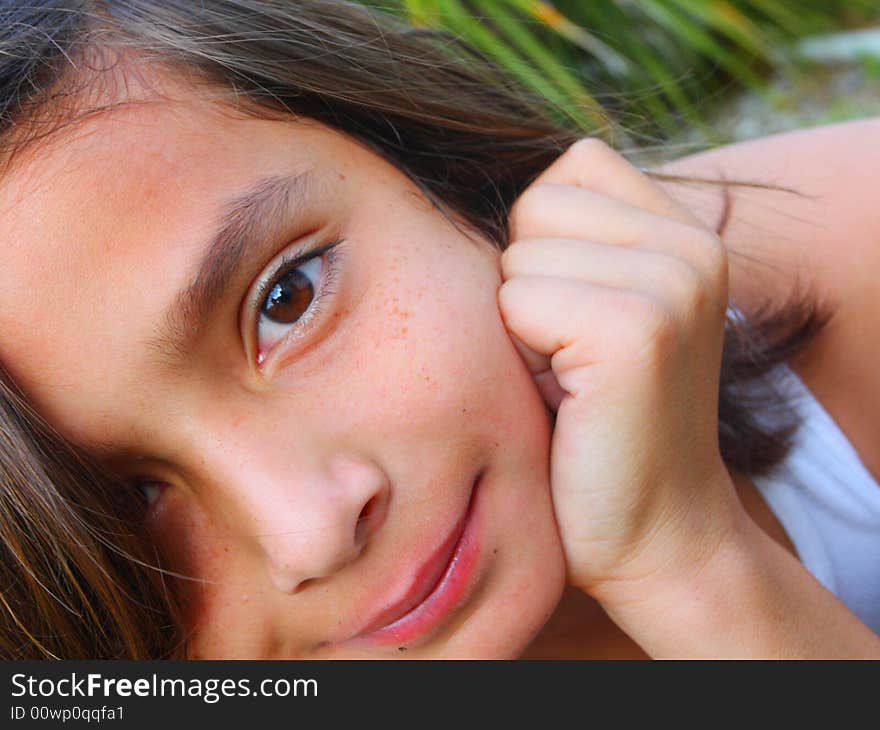 Young caucasian boy looking at the camera with his hand by his head. Young caucasian boy looking at the camera with his hand by his head.