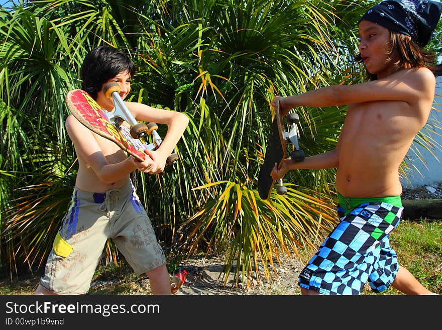 Two kids fighting with skateboards. Two kids fighting with skateboards.