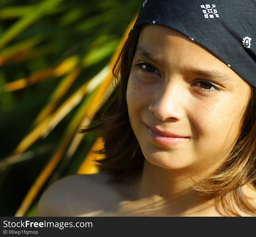 Head and shoulder shot of a young kid wearing a bandanna. Head and shoulder shot of a young kid wearing a bandanna.