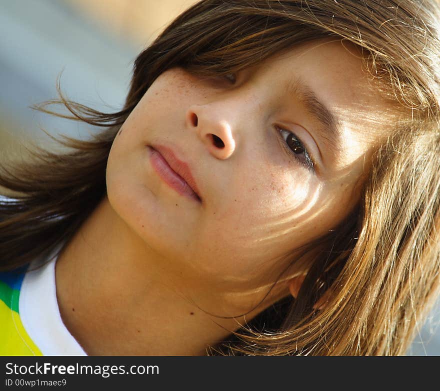 Headshot of a young child with his hair covering part of his face. Headshot of a young child with his hair covering part of his face.