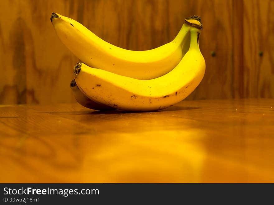 Bananas lyings on the wooden table, yellow fruit