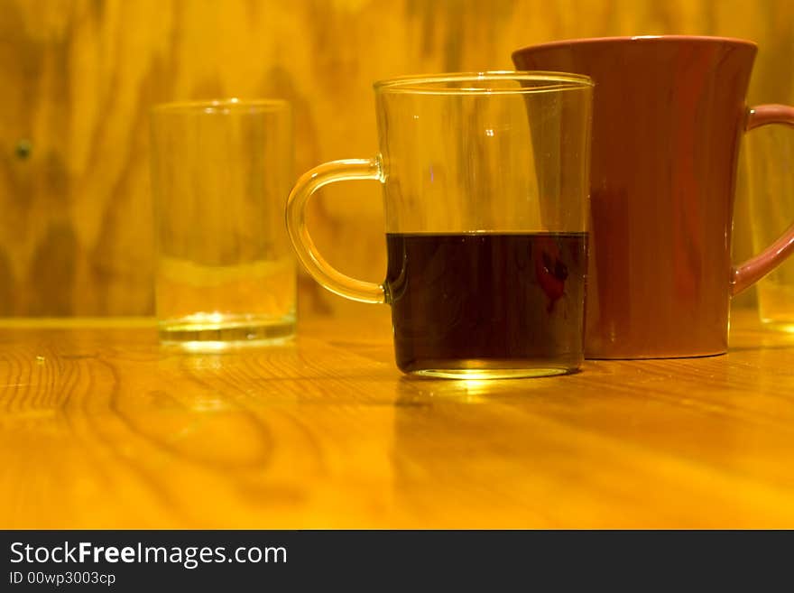 Two glasses and mug the photo on the wooden table. Two glasses and mug the photo on the wooden table