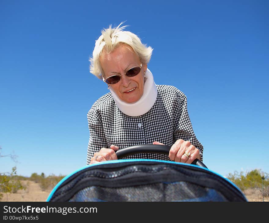 Grandmother Pushing Stroller In Desert