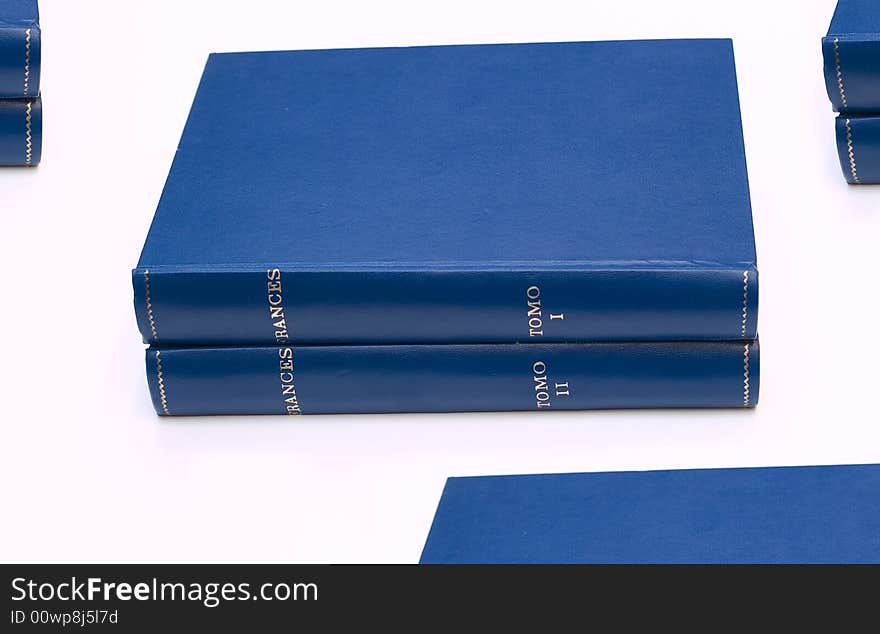 Stacks of books on white background.