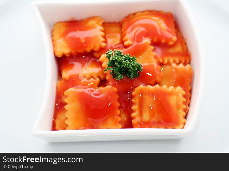 Italian pasta called raviolis with tomatoesauce