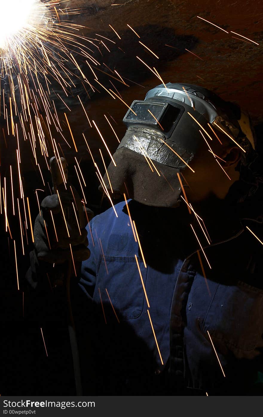 A welder working at shipyard at night. A welder working at shipyard at night