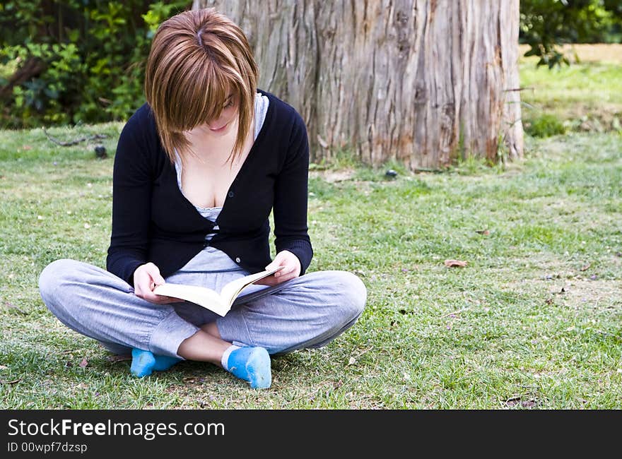 Young woman reading in the park