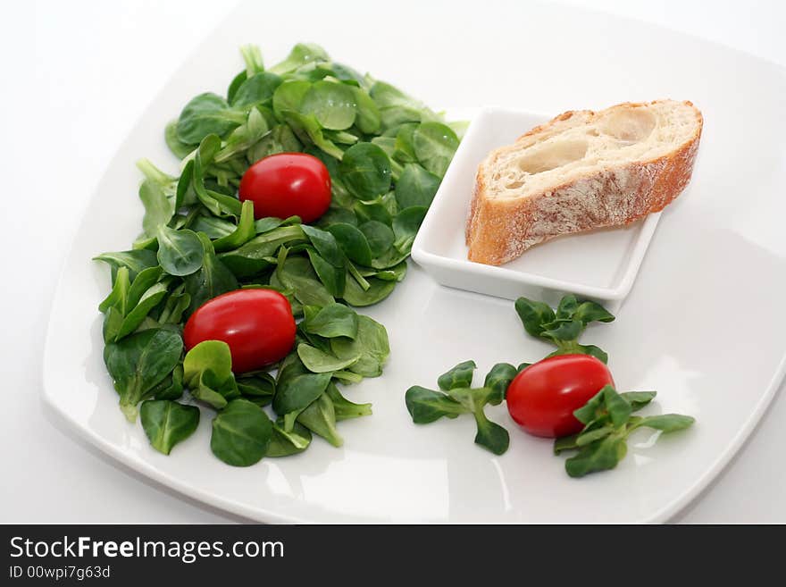 Fresh salad, tomatoes and some bread