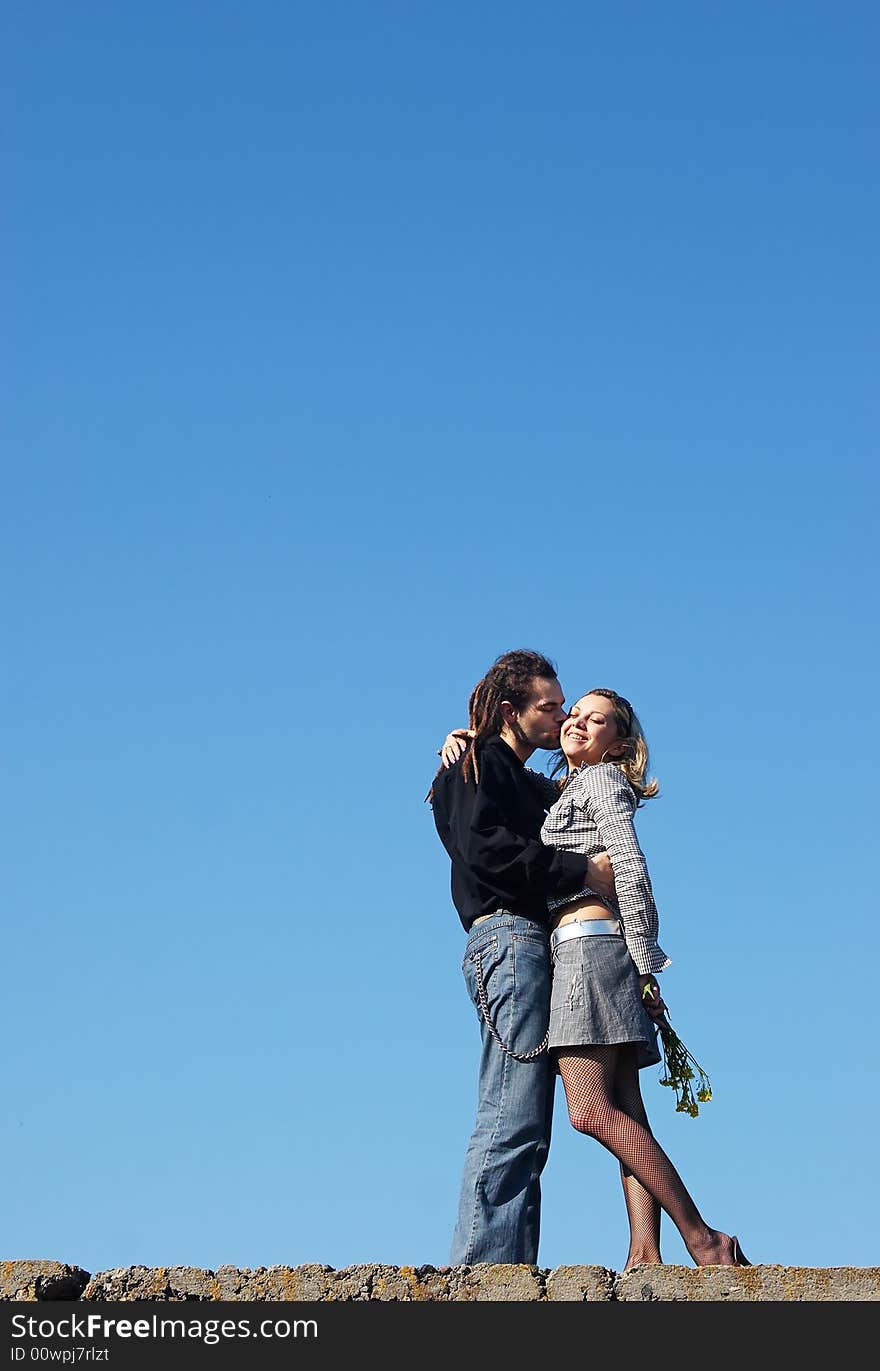 Couple strong kissing under the sky. Couple strong kissing under the sky