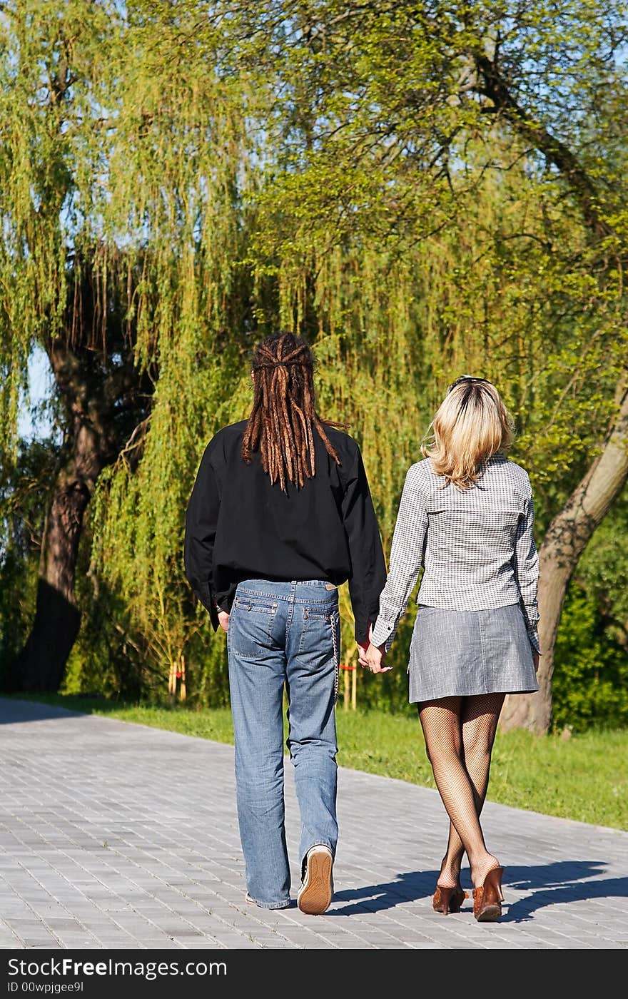 Couple walking on road away. Couple walking on road away