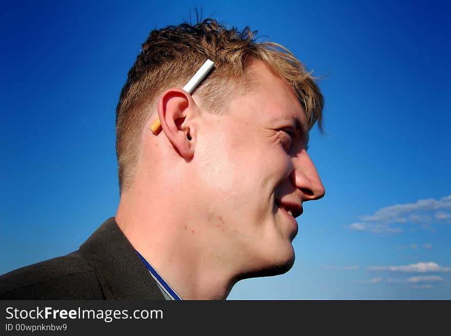 Portrait of a young man with a cigarette, by the sunny weather