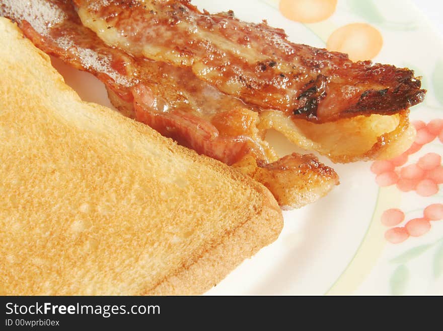 Crispy Streaked Bacon with Toast Bread on white background