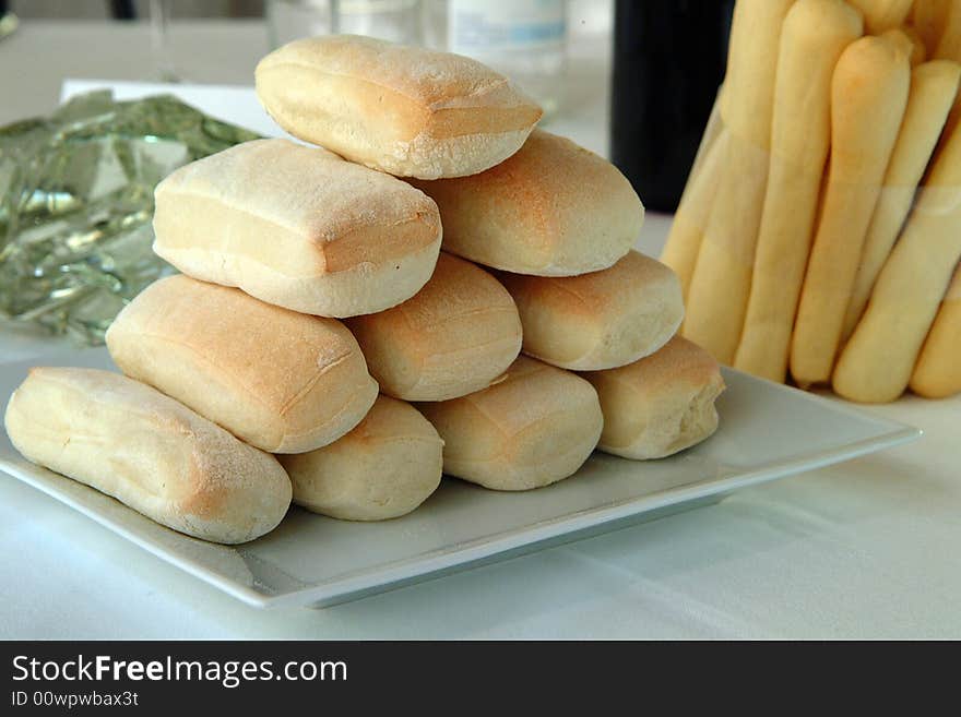 Bread and breadsticks on a white plate. Bread and breadsticks on a white plate