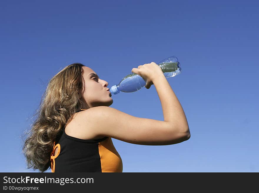 Girl drinking water in the park