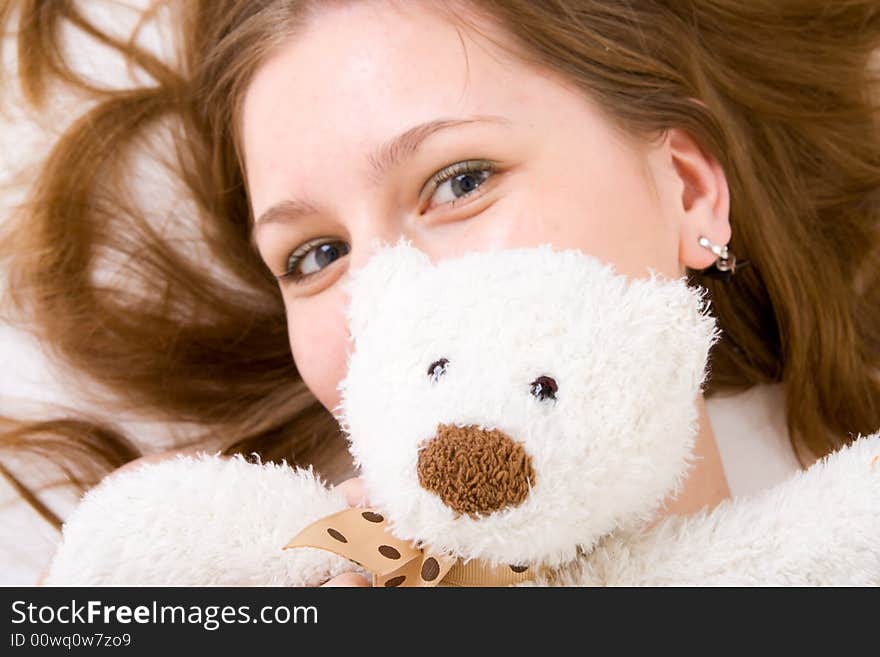 The young attractive girl with a teddy bear