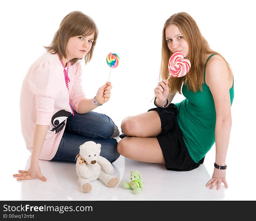 The two young attractive girls isolated on a white