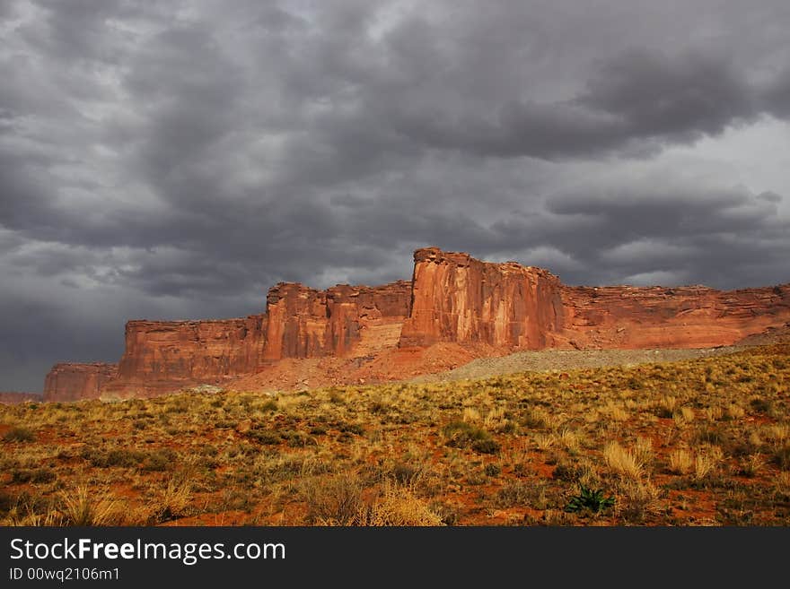 View of the red rock formations in Canyonlands National Park with storm clouds. View of the red rock formations in Canyonlands National Park with storm clouds