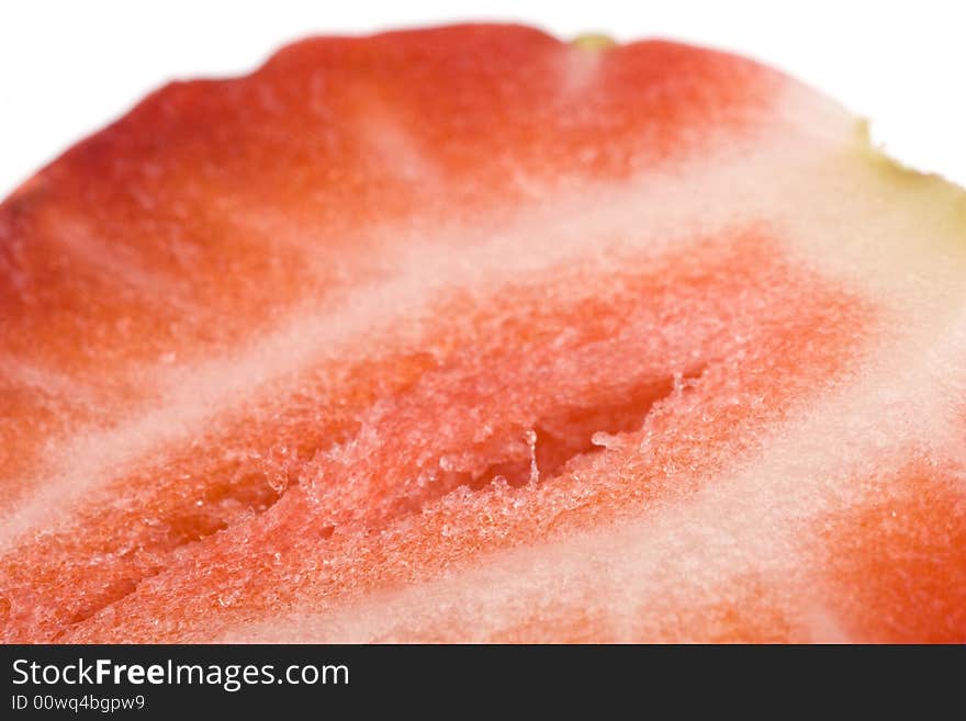 Close up of half of strawberry on a white