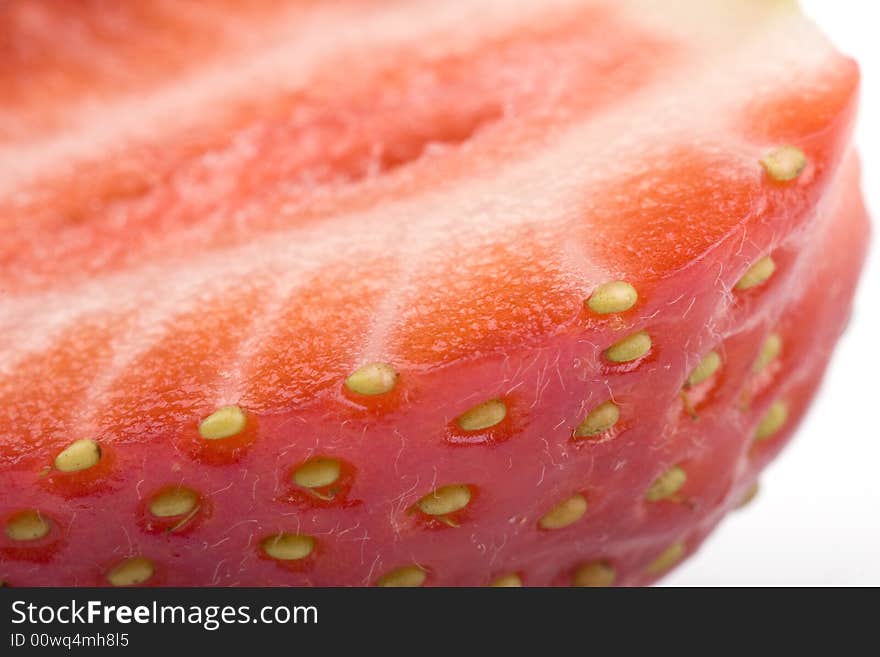 Close up of half of strawberry on a white