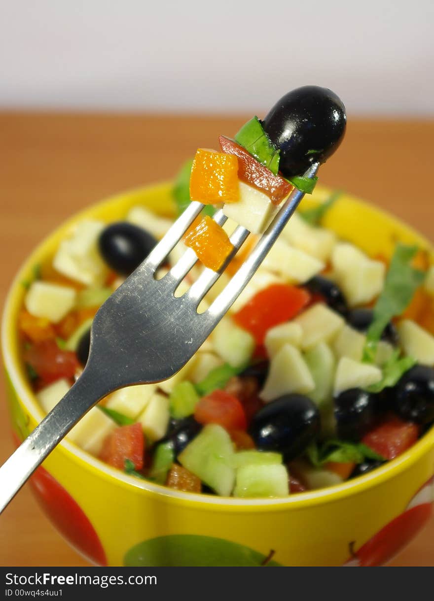 The Greek salad in a bright ceramic plate