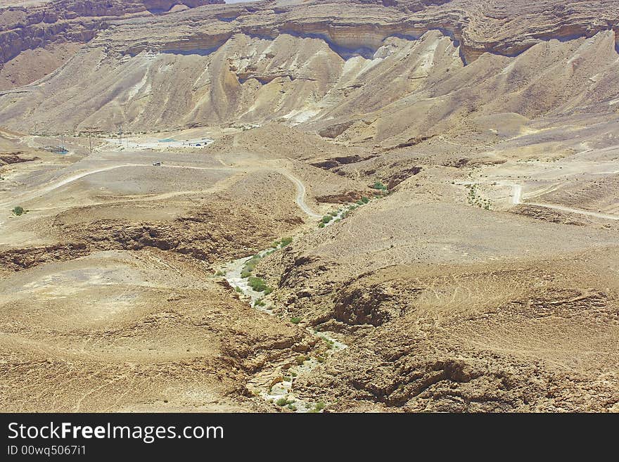 Hills and stones of Judean desert. Channel of the dried up river.