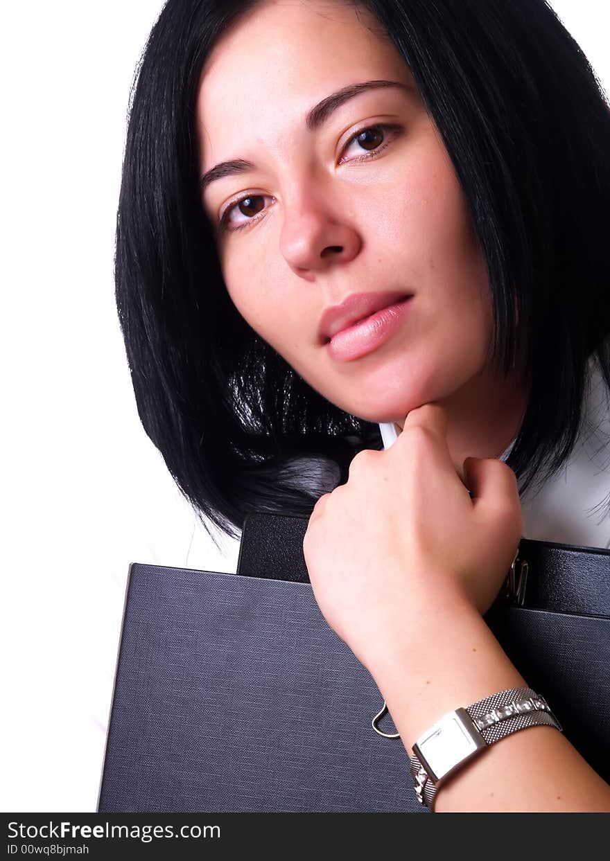 A portrait about a young pretty happy businesswoman with black hair who is holding some folders and she is wearing a white shirt. A portrait about a young pretty happy businesswoman with black hair who is holding some folders and she is wearing a white shirt