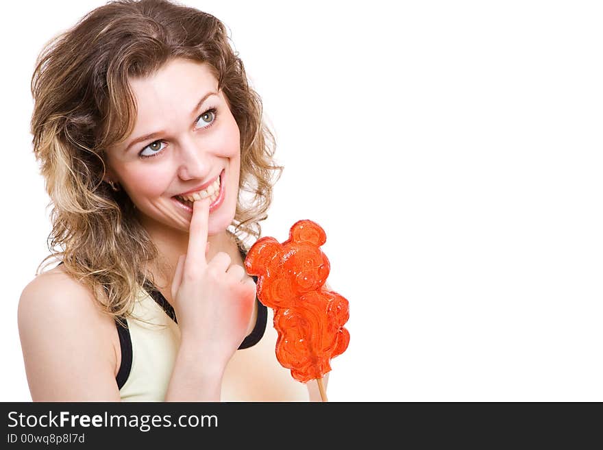 Girl with red lollipop in yellow clothes thinking to eat bonbon. Isolated in white. Girl with red lollipop in yellow clothes thinking to eat bonbon. Isolated in white.