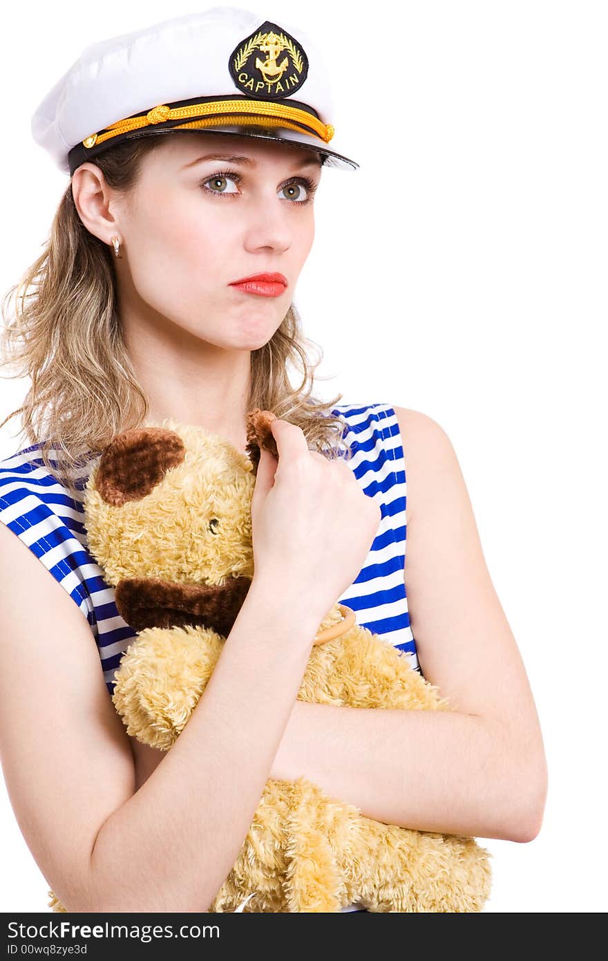 Woman captain in striped clother and her captain hat, taken hands her home small toy . Isolated in white. Woman captain in striped clother and her captain hat, taken hands her home small toy . Isolated in white