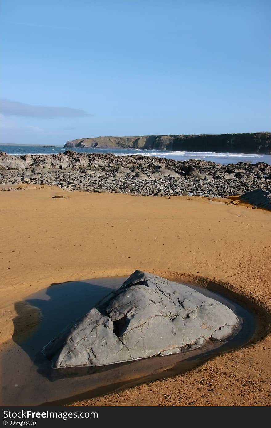 A  golden sandy beach in ballybunion county kerry ireland with a rock pool