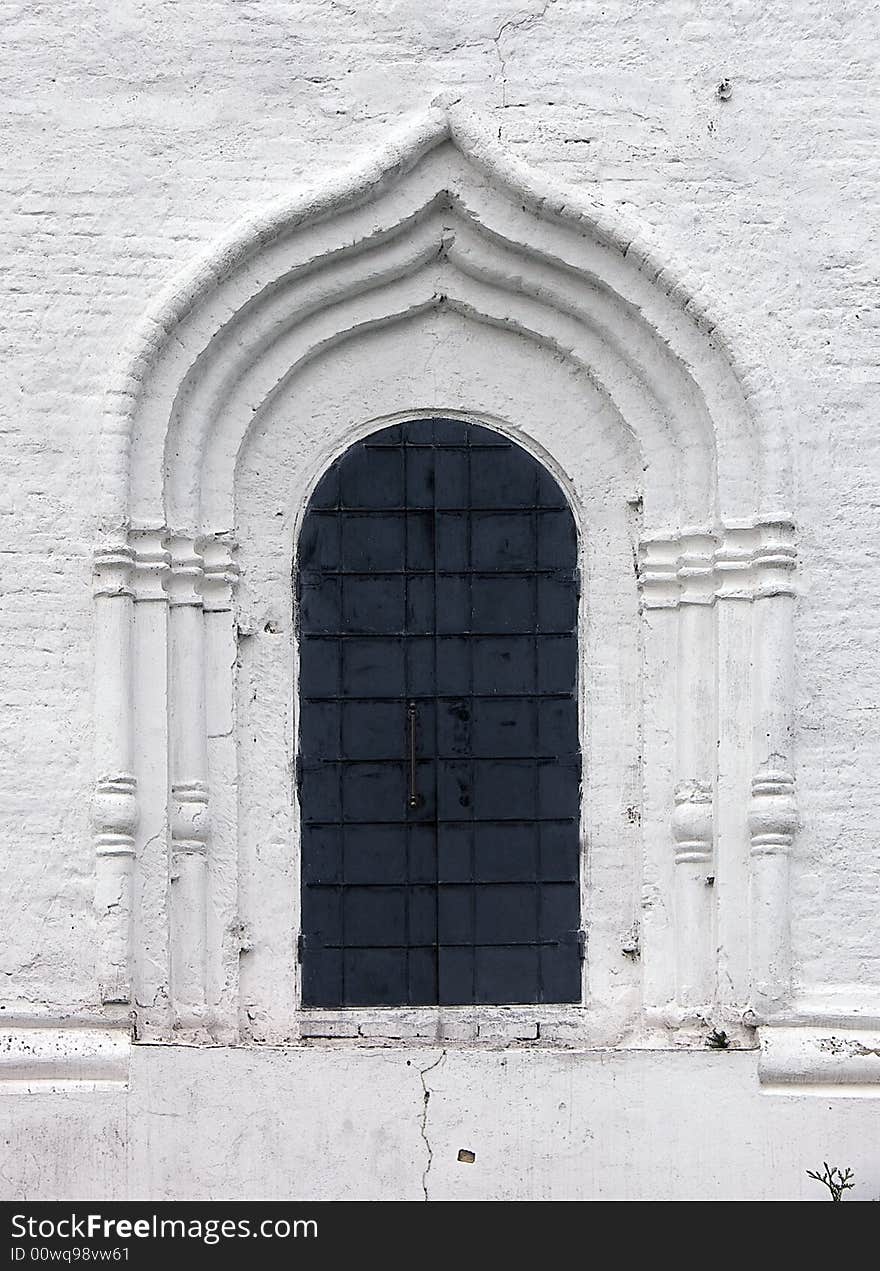 Old window in a wall of a monastery. Old window in a wall of a monastery