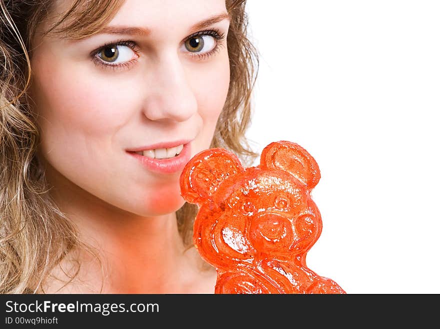 Girl with red lollipop in yellow clothes thinking to eat bonbon. Isolated in white. Girl with red lollipop in yellow clothes thinking to eat bonbon. Isolated in white.