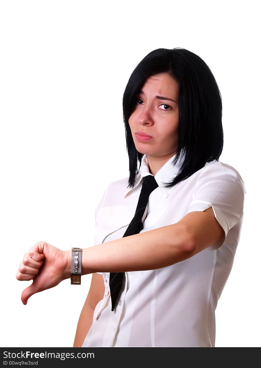 A portrait about a young pretty sad businesswoman with black hair who is giving the thumbs down and she is wearing a white shirt and a black tie. A portrait about a young pretty sad businesswoman with black hair who is giving the thumbs down and she is wearing a white shirt and a black tie