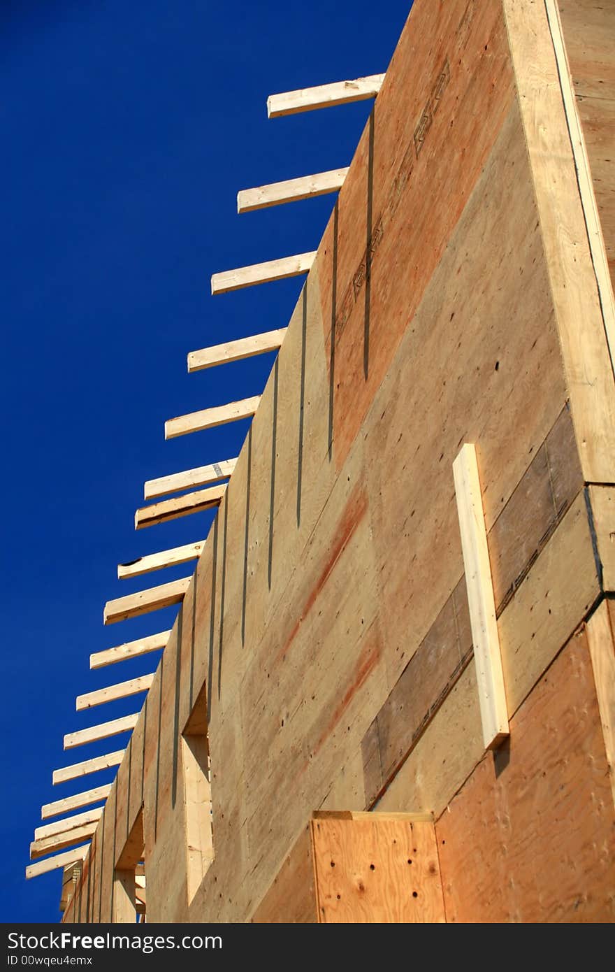 A wood-framed home being built. A wood-framed home being built.