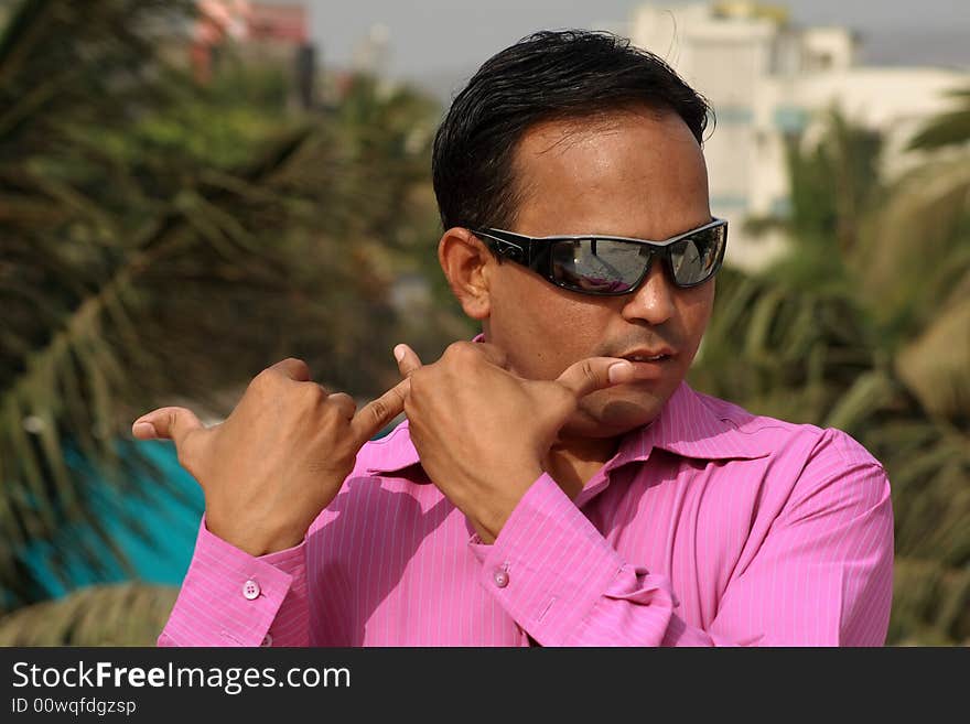 A village guy doing mimicry with his hands symbolizing a flute play. A village guy doing mimicry with his hands symbolizing a flute play.