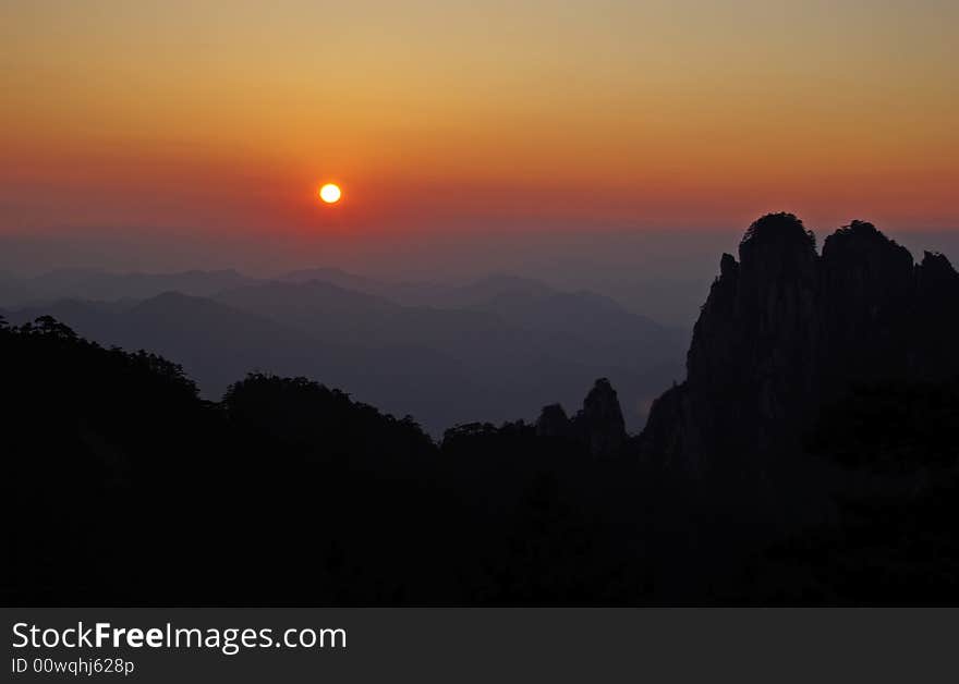 Sunset at purple cloud peak of huangshan mountain