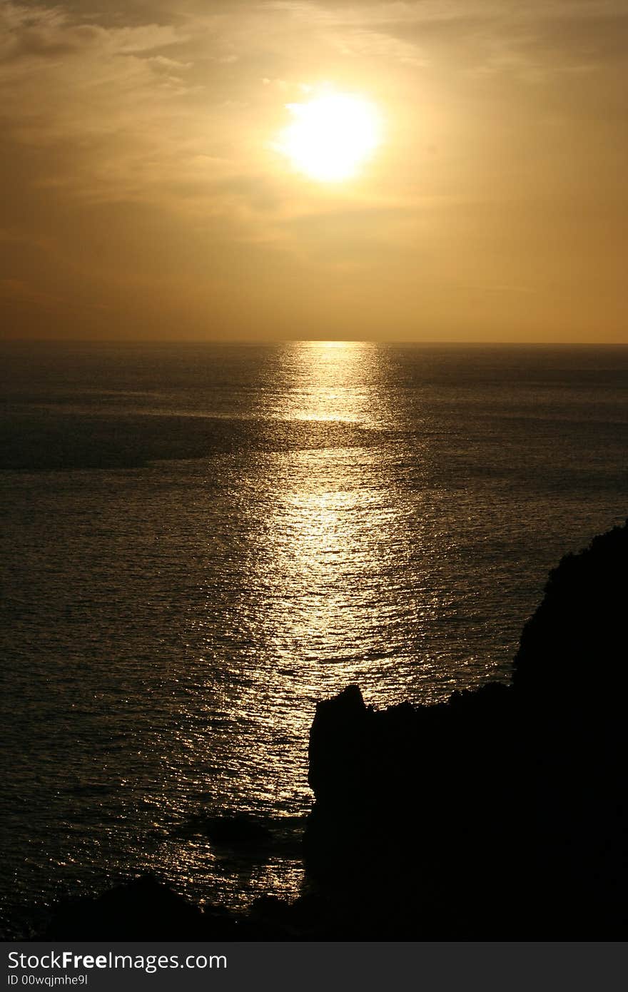 Sun setting on the ocean, photo taken from silveira coast, Pico island Azores. Sun setting on the ocean, photo taken from silveira coast, Pico island Azores