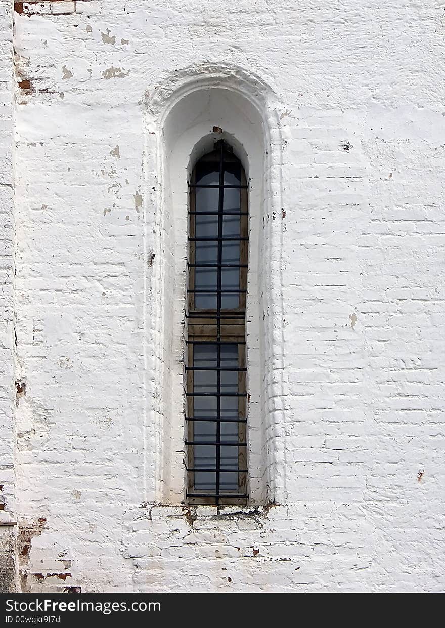 Old window in a wall of a monastery. Old window in a wall of a monastery