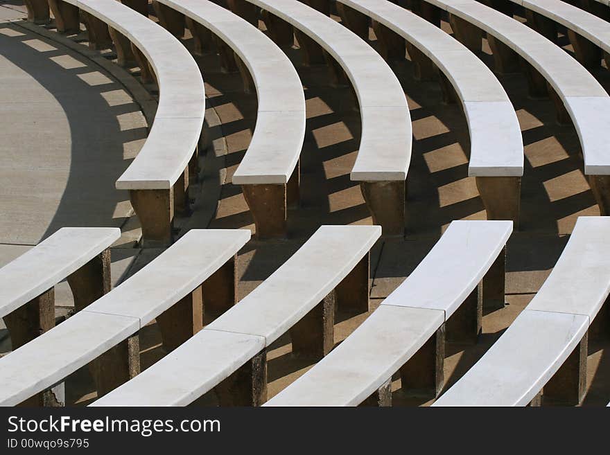 Curved stone benches for outdoor audience seating. Curved stone benches for outdoor audience seating