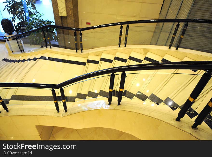 The upward staircase with ceramic stairs in a luxury building. The upward staircase with ceramic stairs in a luxury building.