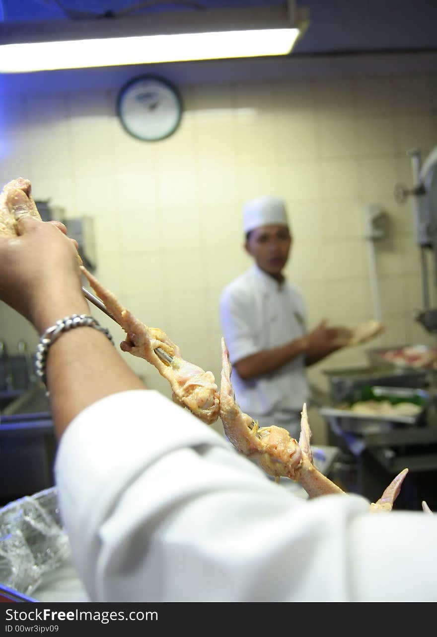 Processing chicken kebab in butcher