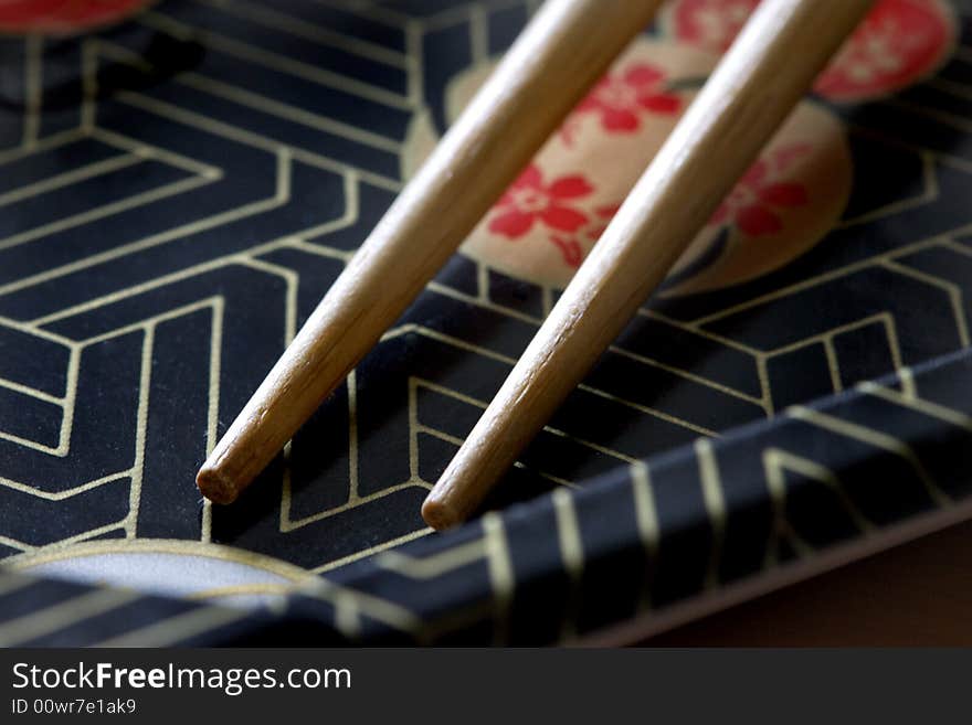 A japanese tray perfect with a pair of chopstick with natural side lighting. A japanese tray perfect with a pair of chopstick with natural side lighting