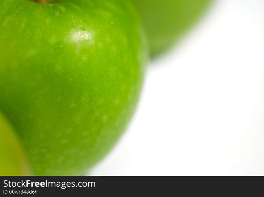 Fresh green apples on a white backdrop