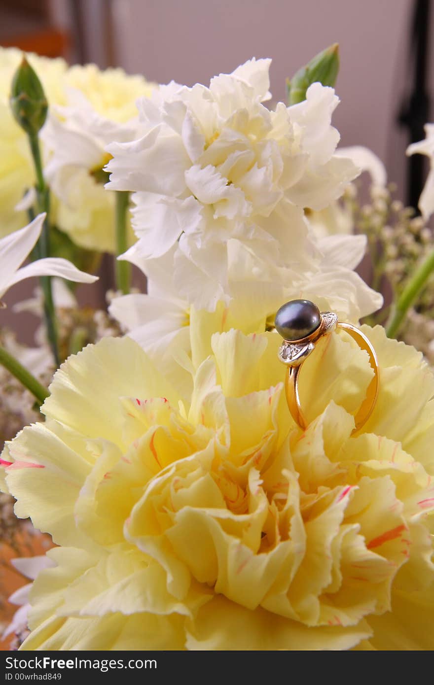 Ring with blue pearl on flowers