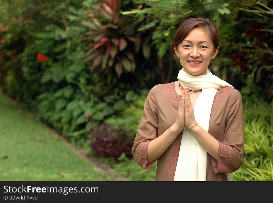 A blissful Hare Krishna Chinese devotee greeting at garden. A blissful Hare Krishna Chinese devotee greeting at garden.